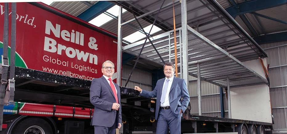 Colin Moody, Managing Director and Carl Andrew, Logistics Director with a double-deck trailer in the