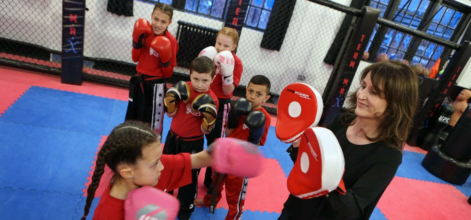 Christine Bell, a Director at Boro Taxis spars with Saran Hill watched by Angeli Ullah, Warren Green