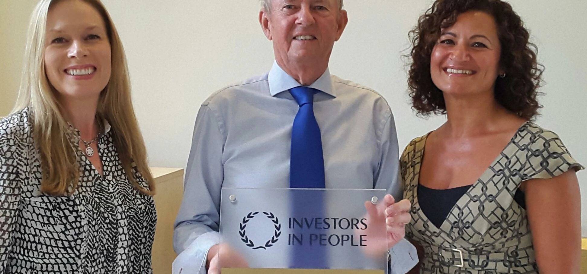 Anna Whittaker, Clive Newton and Rukhsana Nabi show off the company's latest accolade