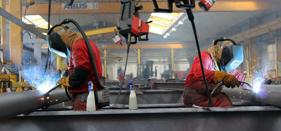 Finley Structures employees creating the steel framework for A&H Construction