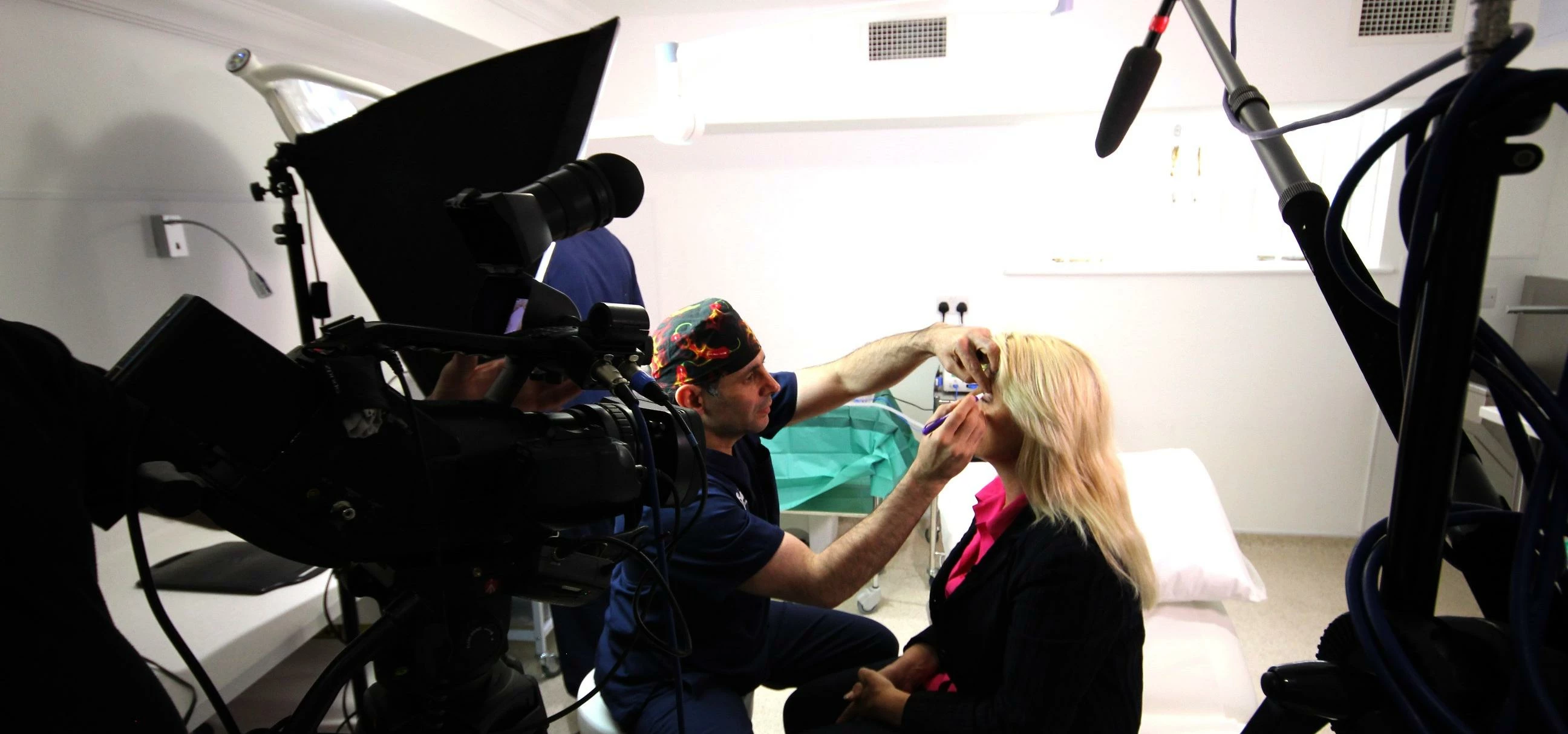 Lead surgeon Amir Nakhdjevani preps a patient for eyelid surgery