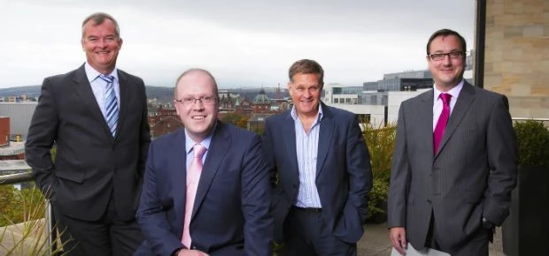 Russell Hall (sitting) with colleagues from the Real Estate team