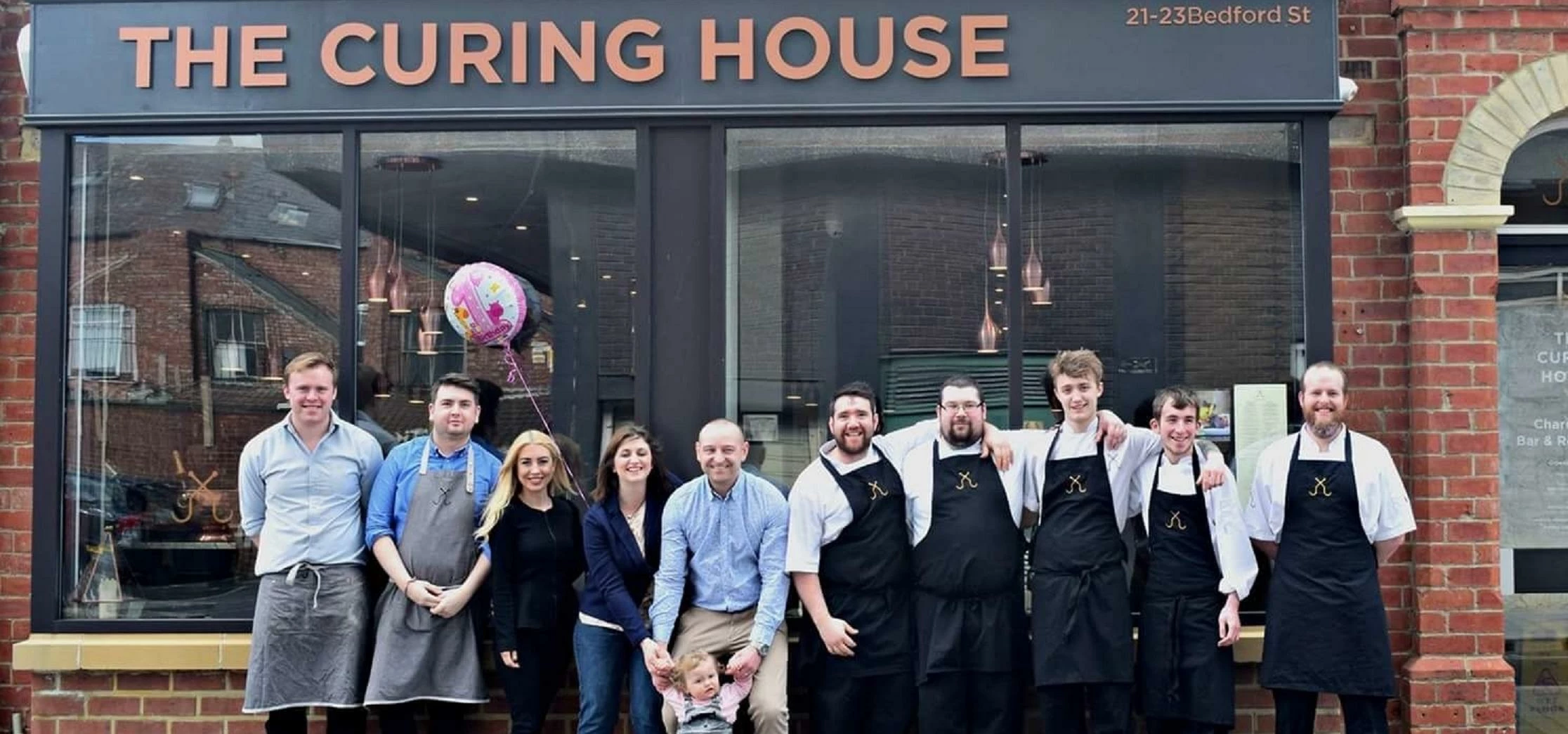 The Curing House team with Sarah and Peter Walker and their 1 year-old, Anna, at the front