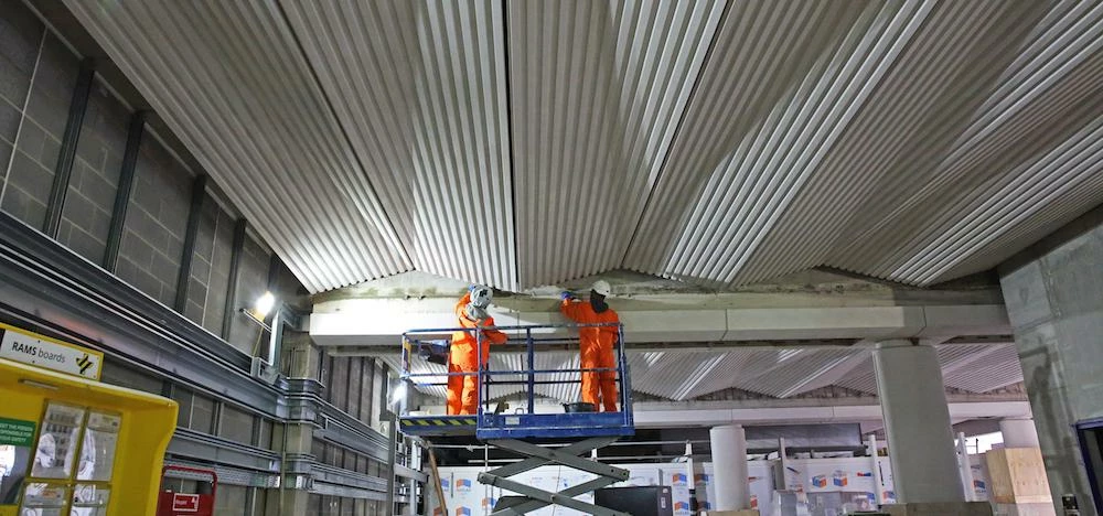 Construction workers fitting the new ceiling at Liverpool Street.