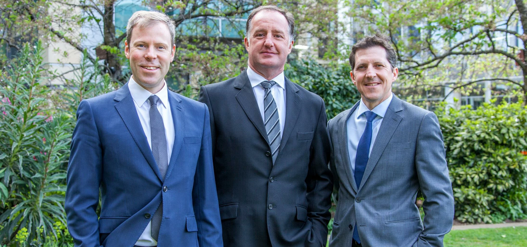 Taylor&Emmet's chief executive, Anthony Long (centre), congratulates James Drydale (left) and Neil R