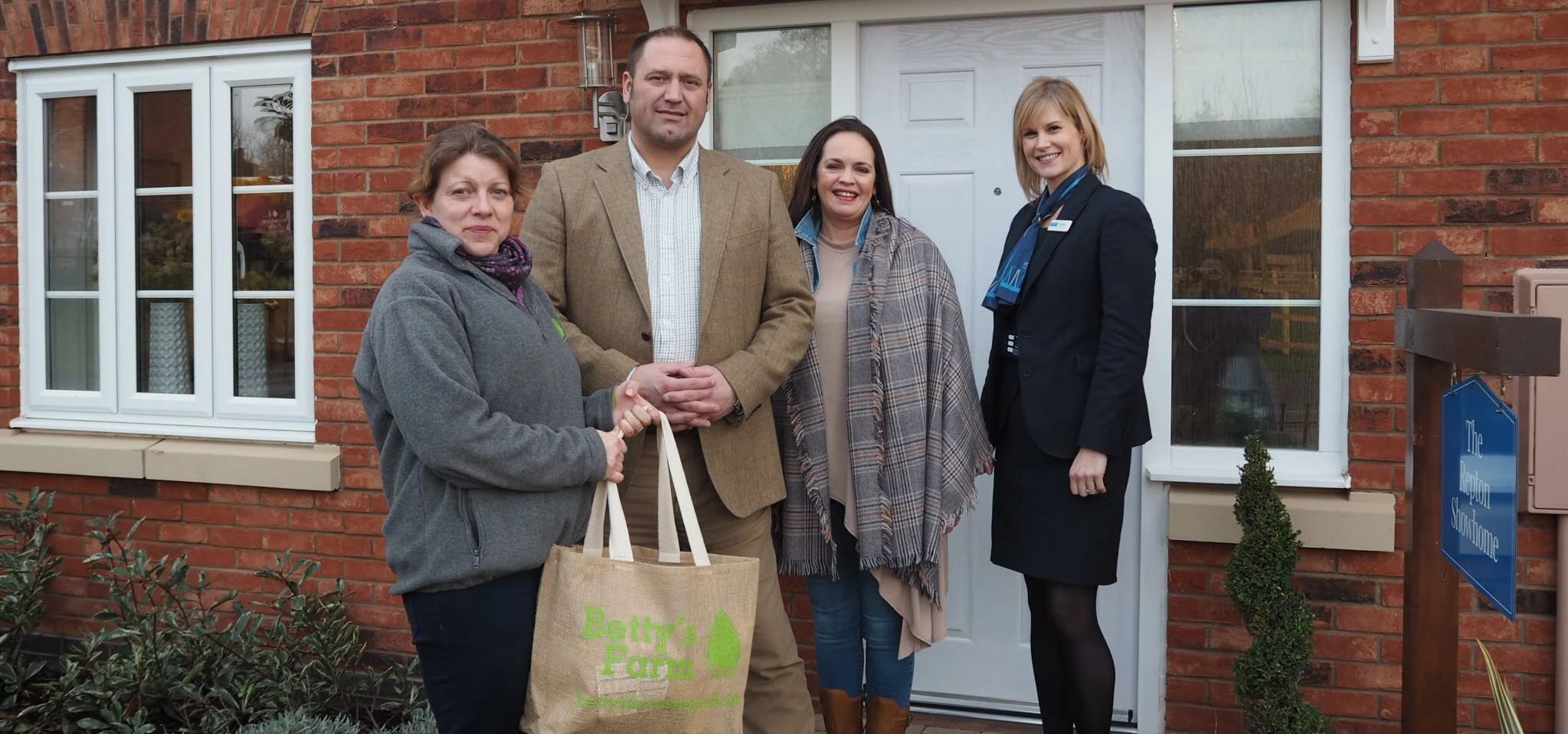 Mark and Karen Cripps with their hamper outside their new home on Brindley Park