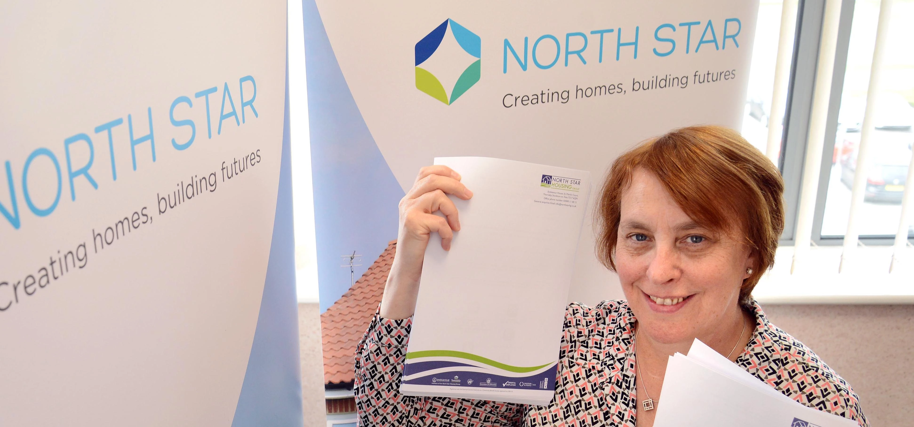 Angela Lockwood, North Star CEO, with old branded paper which will be given to School Aid.
