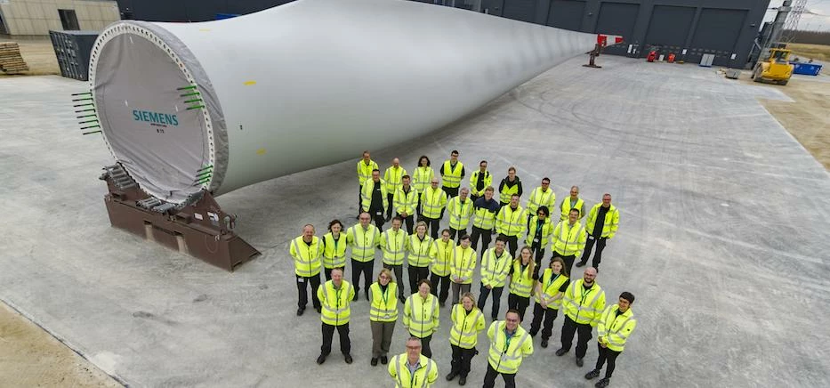 The members of the Siemens Hull team at the company’s Aalborg factory with a 75-metre wind turbine b
