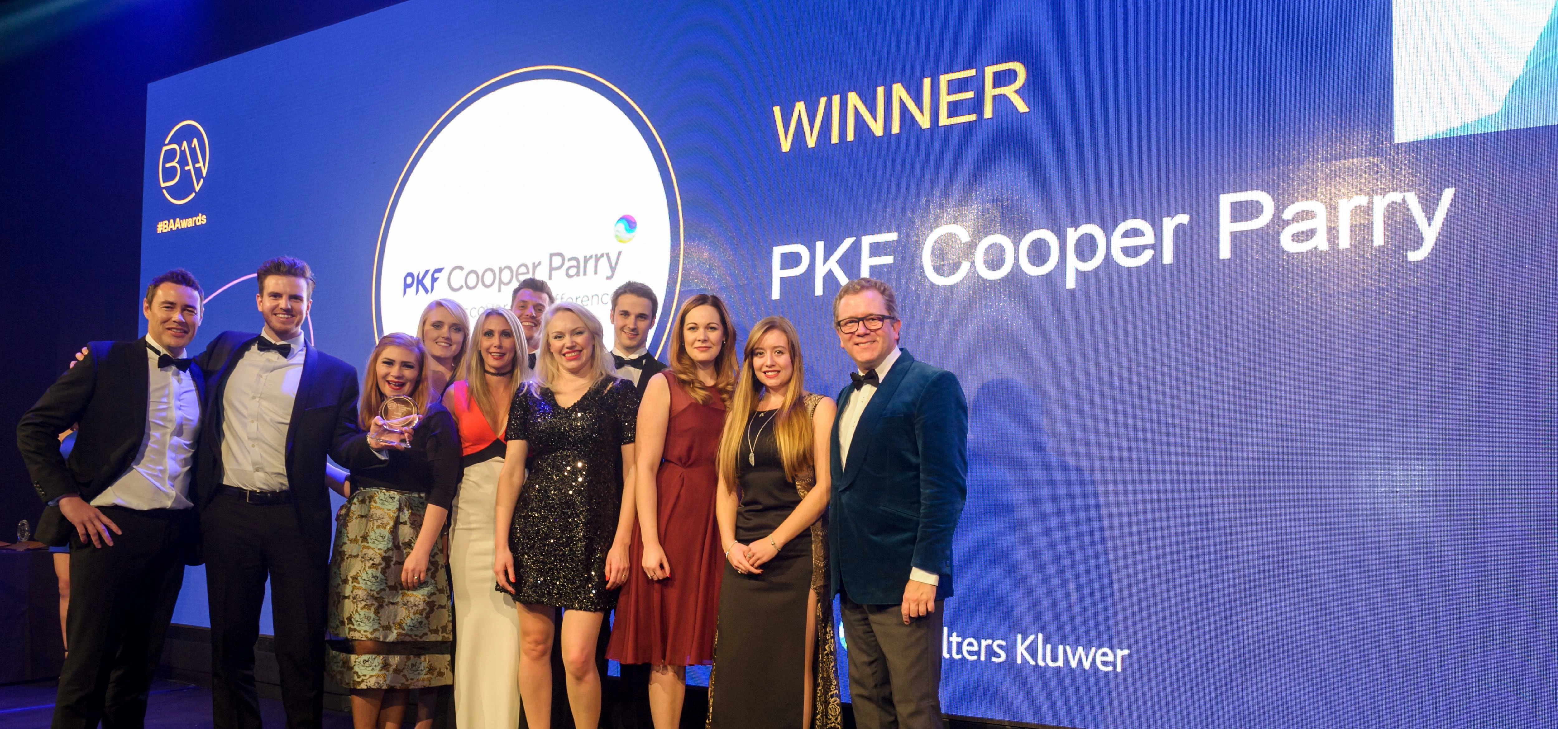 The PKF Cooper Parry team collecting their award from the British Accountancy Awards 2016 host, John