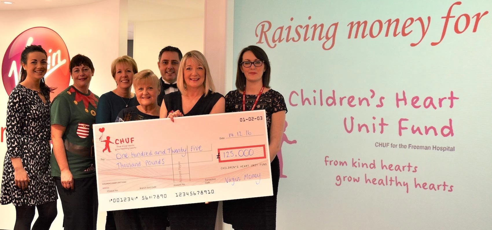Members of the Virgin Money team celebrate their fundraising efforts with CHUF
