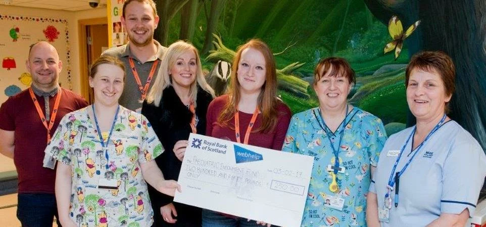Webhelp Kilmarnock present a cheque for £250 to staff at the children's ward of Crosshouse Hospital