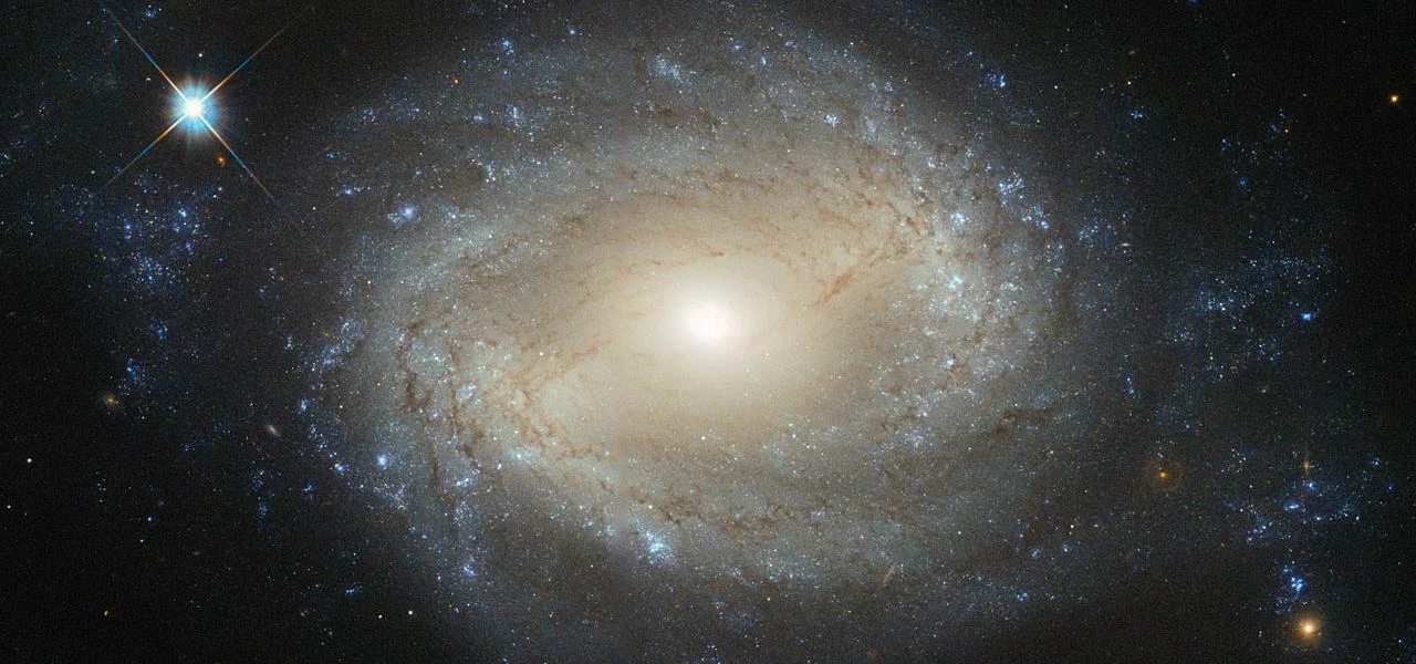 Hubble Sees Elegant Spiral Hiding a Hungry Monster