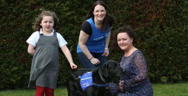 From left to right: Seven year old Elizabeth Gregor with her support dog Oyster, Latimer Hinks Solic
