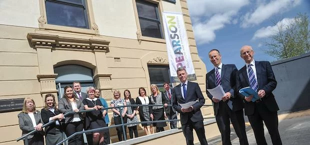 Pearson staff outside the new offices in Ashton
