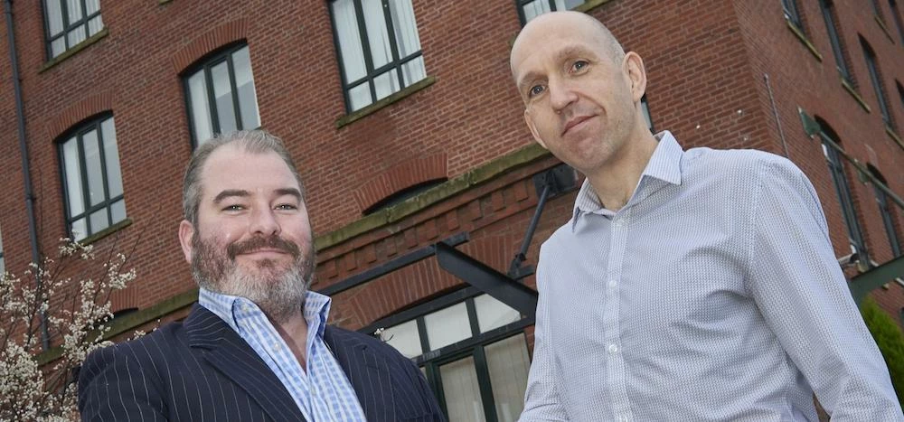 Jeremy Meredith (left) with David Grunnill outside the Oldham office