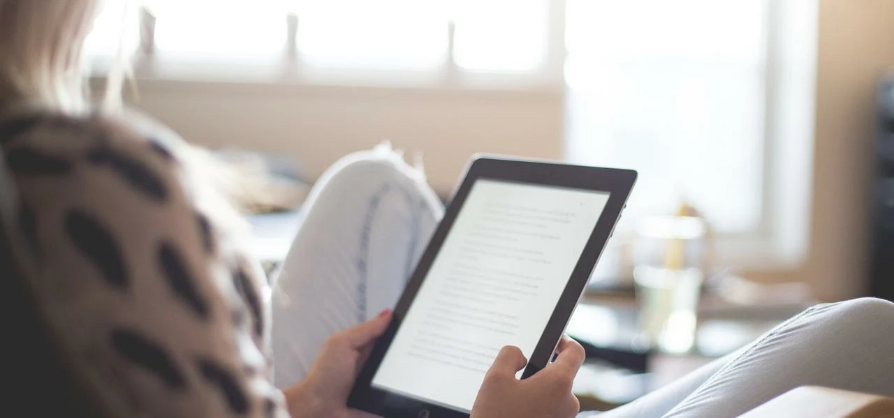 Woman Sitting on Chair Using Black Ipad- Credit to https://costculator.com/