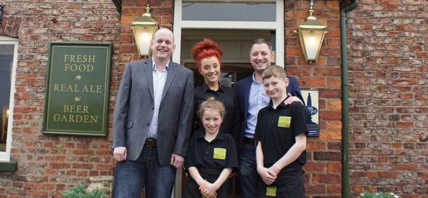 The Drovers Arms new owners Martin Firth (far left) and Graham Usher (far right) with Graham’s child