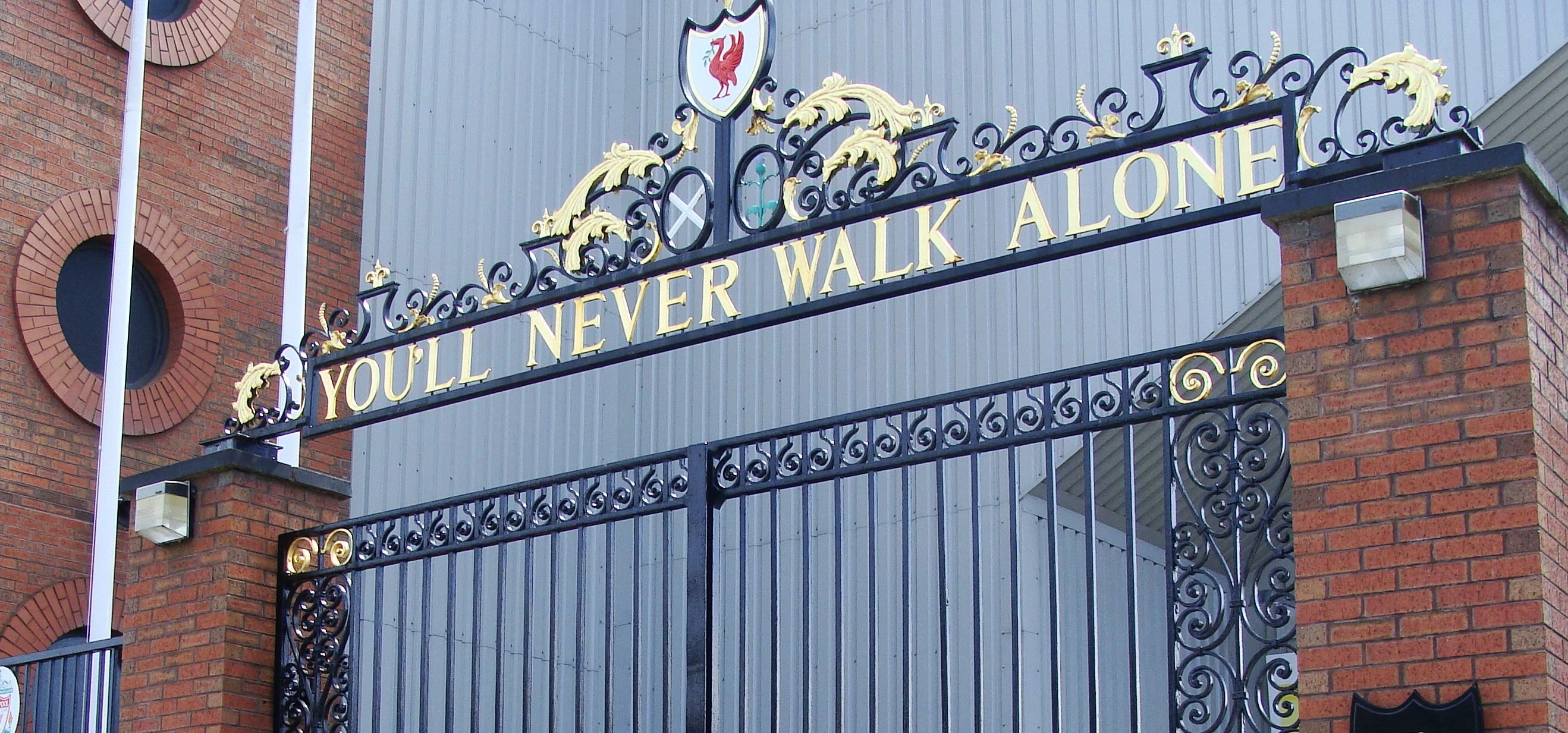 The You'll Never Walk Alone gates with flowers and scarfs