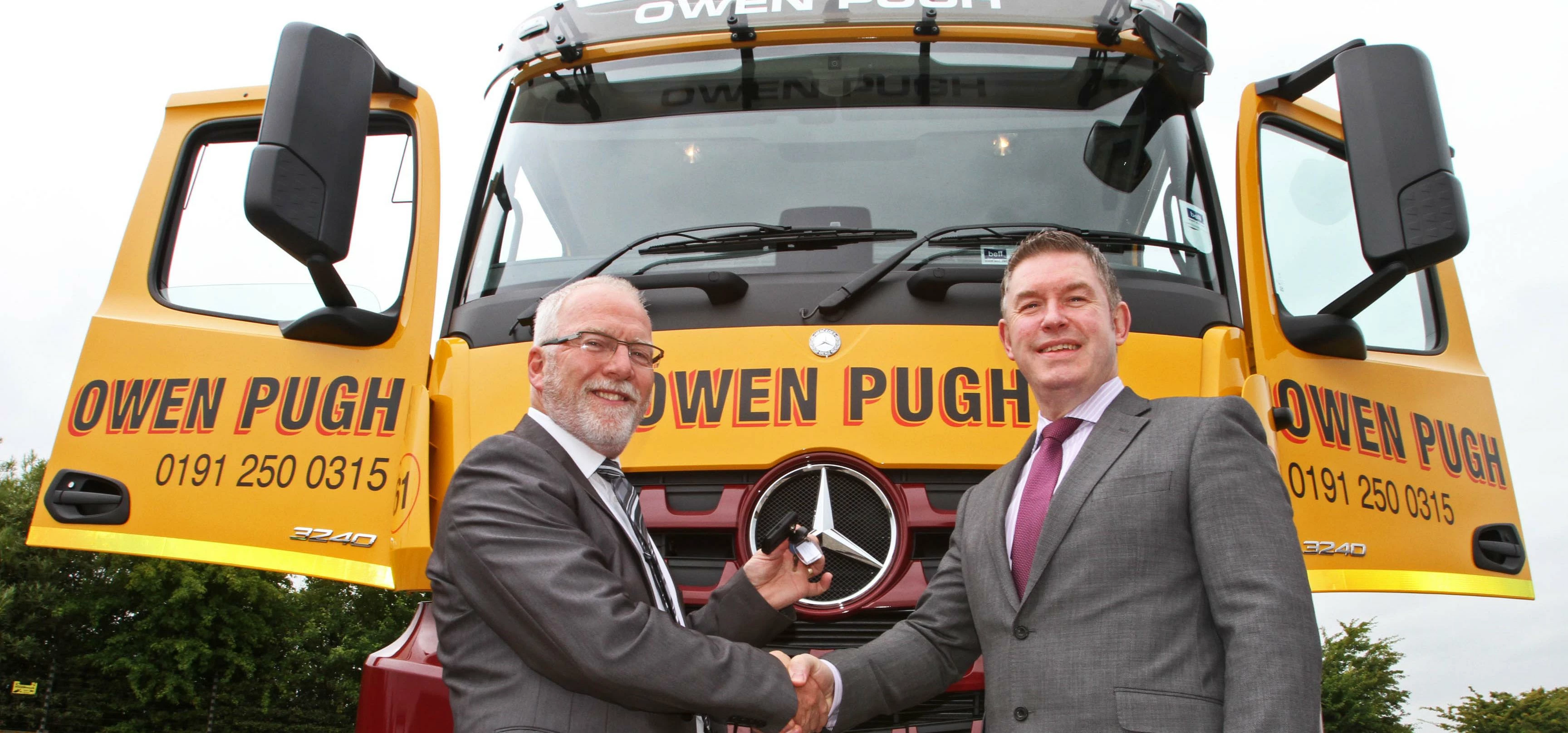 Trevor Simmons of Bell Truck & Van presents Owen Pugh's Paul Cockburn with the keys to the new truck