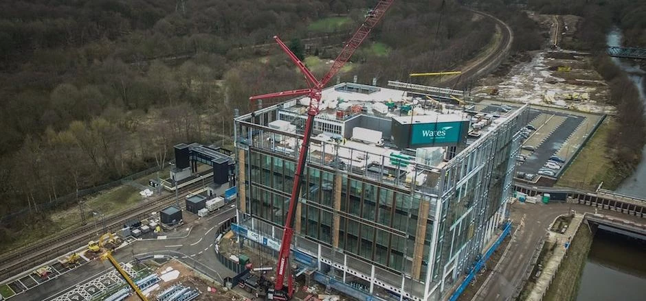 The 15 tonne plant room being hoisted onto the seventh storey of the Kirkstall Forge development.