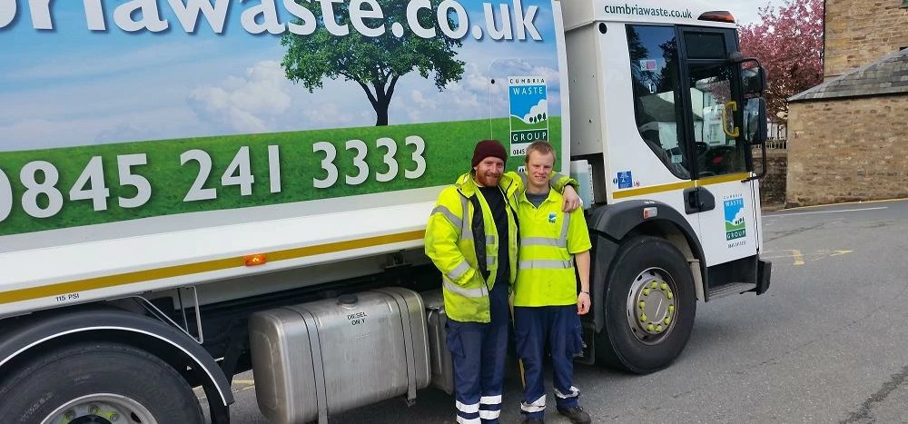 Jonathan and Chris next to one of the vehicles they can now drive.