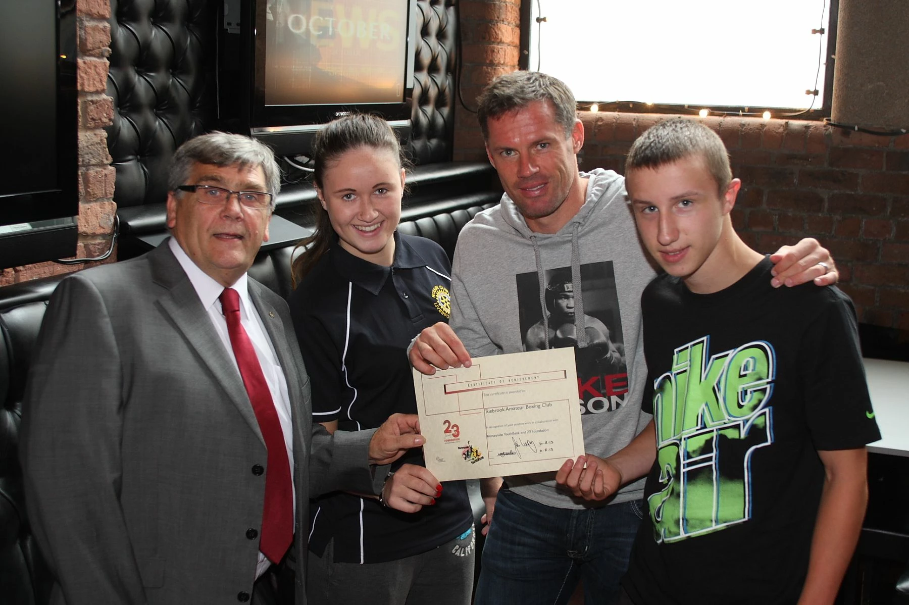 Liverpool FC legend Jamie Carragher with members of the Merseyside YouthBank.