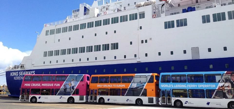 Go North East buses in front of a DFDS ferry.