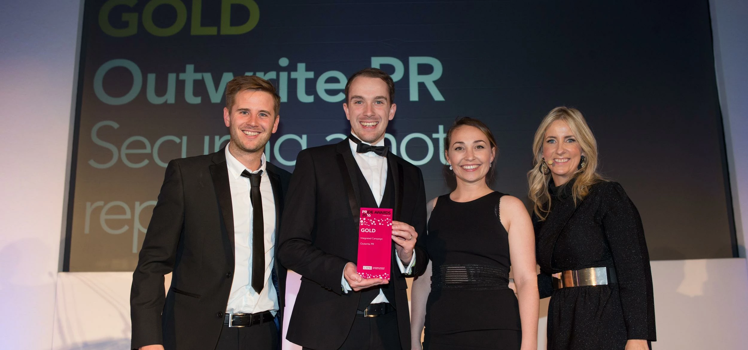 Outwrite PR's Anthony and Stacey (centre) accept the award. 
