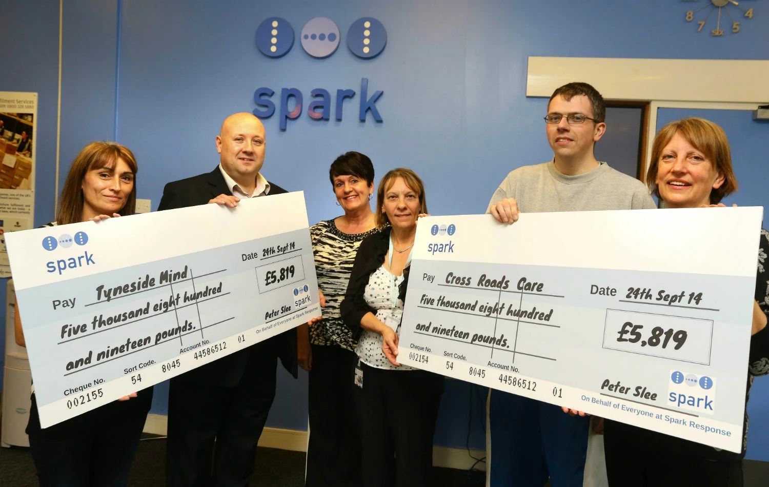 Staff at Spark make a donation