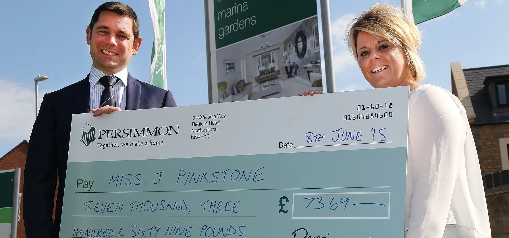 Joanne Pinkstone receives her prize from Persimmon Homes Midlands managing director Richard Oldroyd.