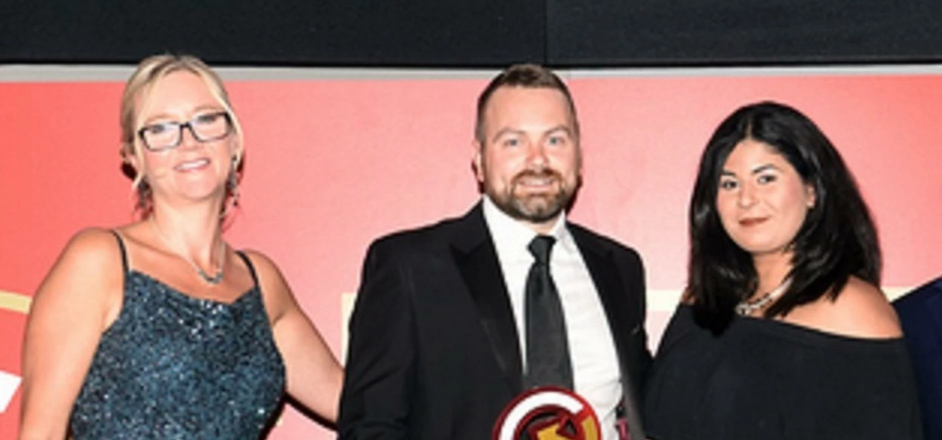 Philip Brennan and Kareema Ali accept the award from host Kate Russell