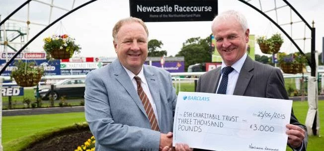 Esh Group Chief Executive Brian Manning (left) receives the cheque from Mike Elliott from Newcastle