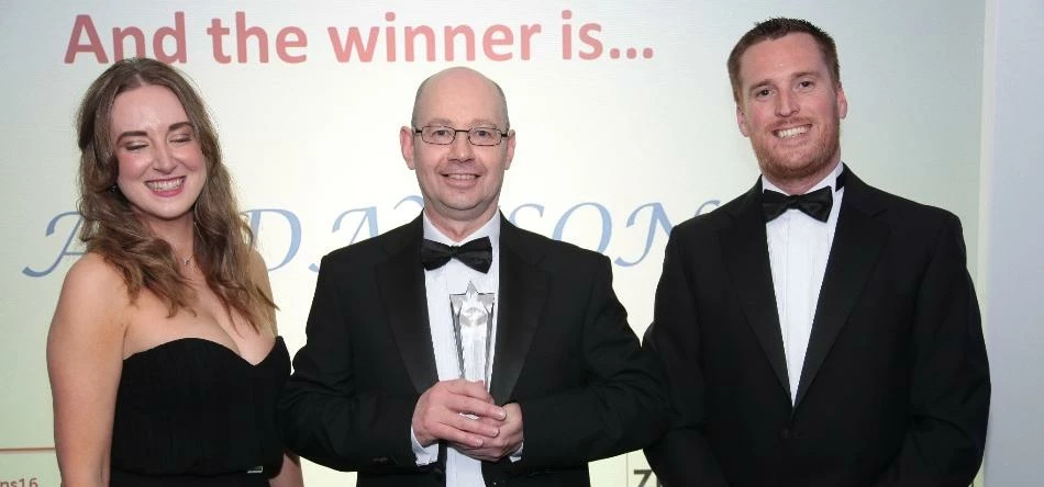 Neil McShane (centre), AV Dawson Quality Manager collects the Warehousing Award at the Freight Indus