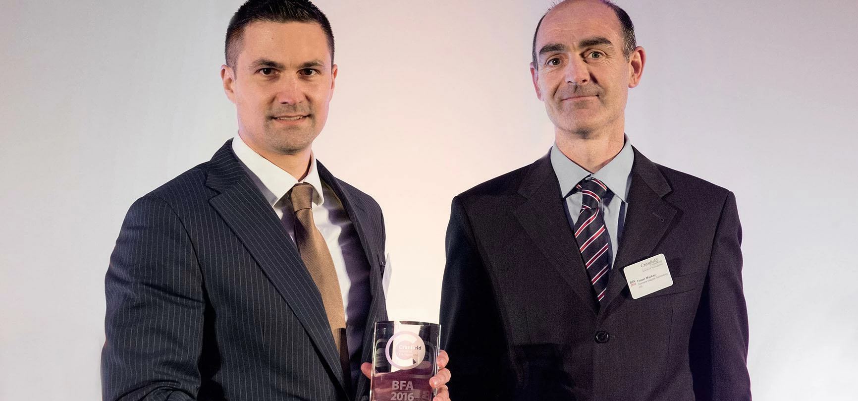 (l-r) Juergen Zahl (Brose UK) receiving the award from Frazer Mackay of Siemens Magnet Technology, w