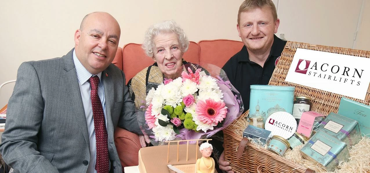 Edna Hughes celebrates 99th birthday with Acorn Stairlifts' Geoff Goodman (l) and Dave Sharkey (r)