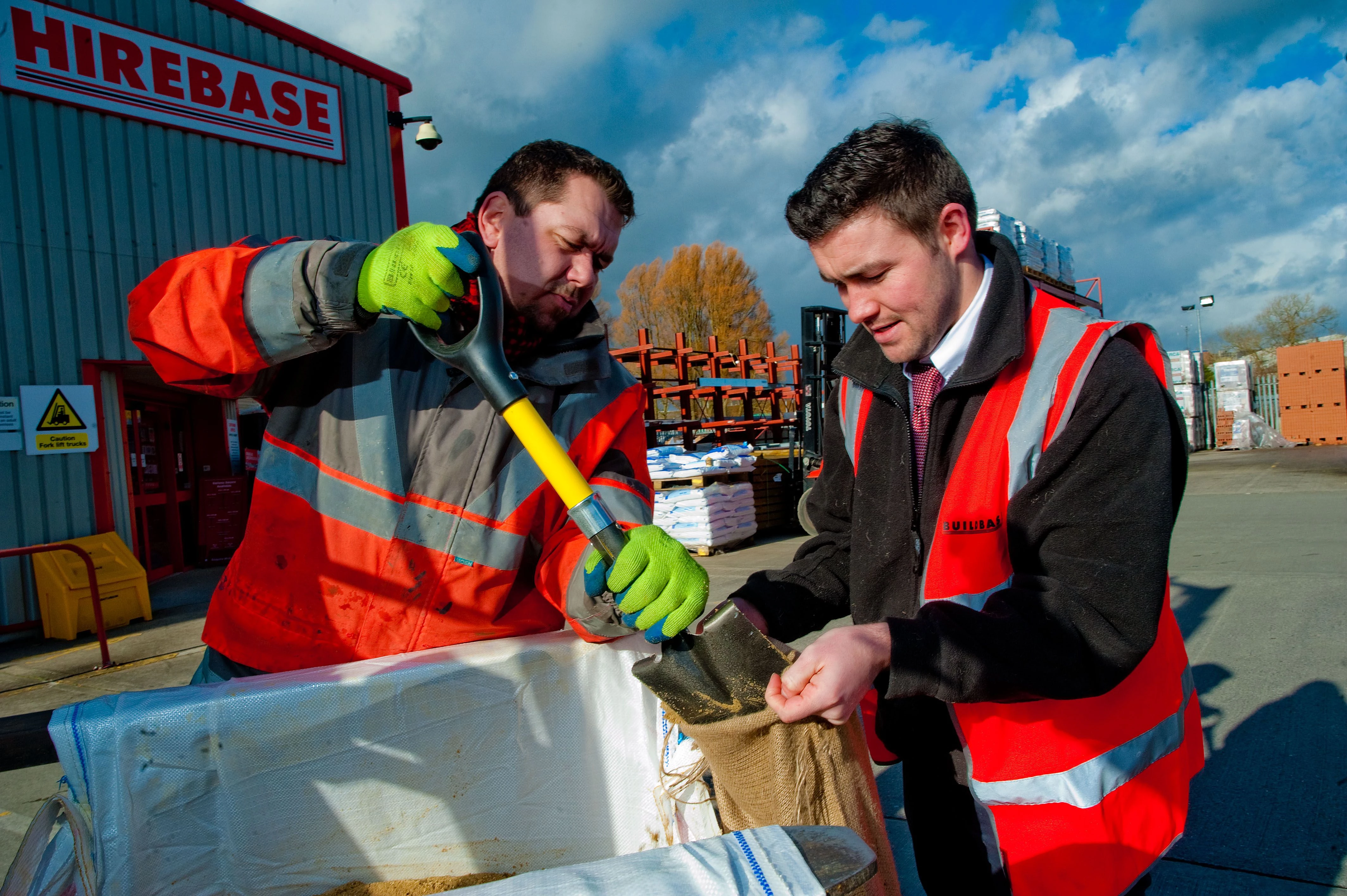 Filling sandbags for flood relief at Buildbase Yeovil