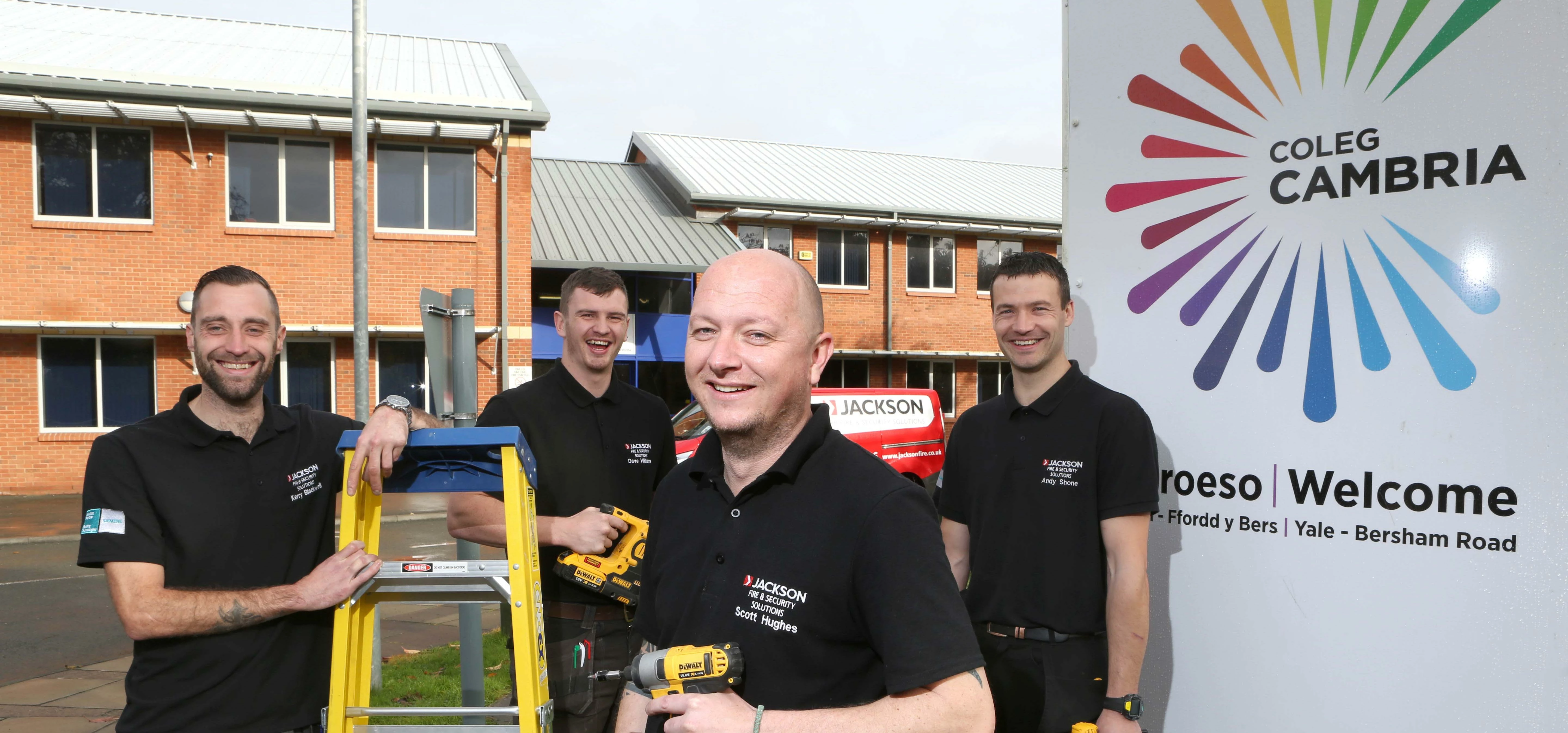 Jackson Fire installation engineer Scott Hughes (centre), back in the classroom at Coleg Cambria, Wr