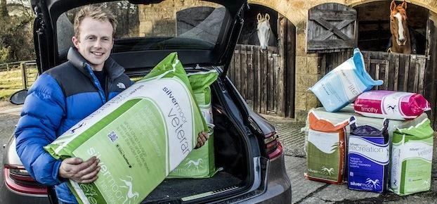 Ralph Thompson, Managing Director of Silvermoor Haylage with horses and haylage product.