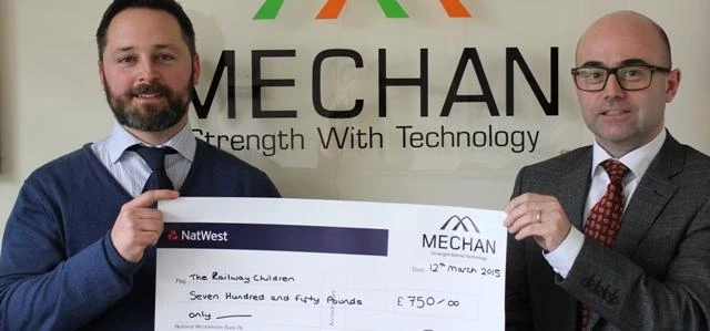 Mechan managing director, Richard Carr, presents a cheque for money donated by the firm to Dave Elli
