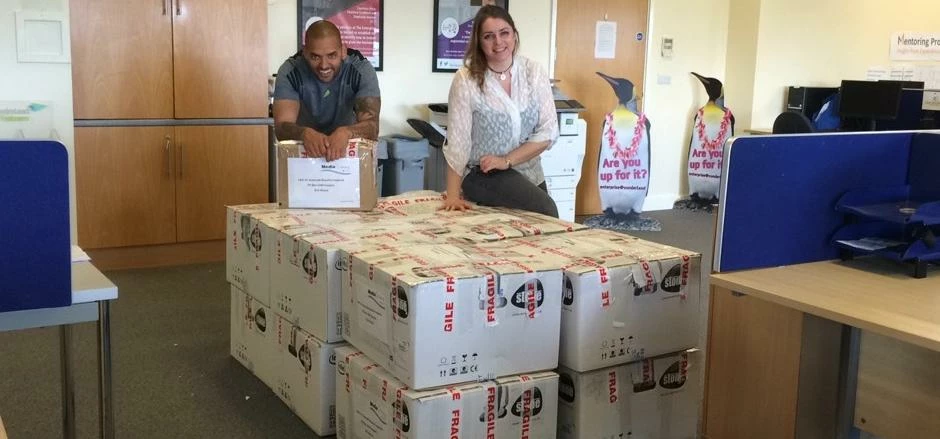 MD Dan Makaveli and colleague Lisa Miller with computers donated from The Enterprise Place, Universi