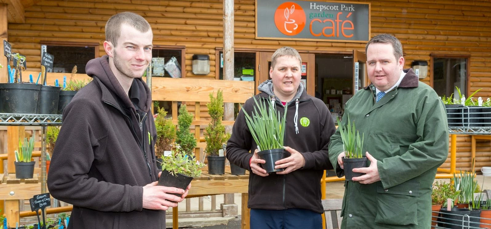 Carl (right) and Richard (centre) with horticulturist Robbie Pendrich and some of the wooden animal