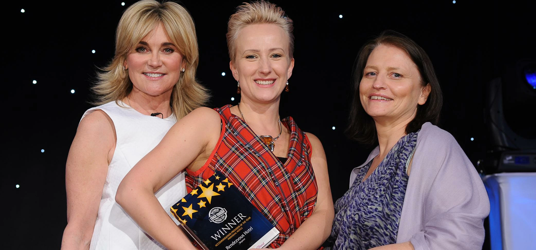 Agata Rusinek (centre) receiving the award from Anthea Turner