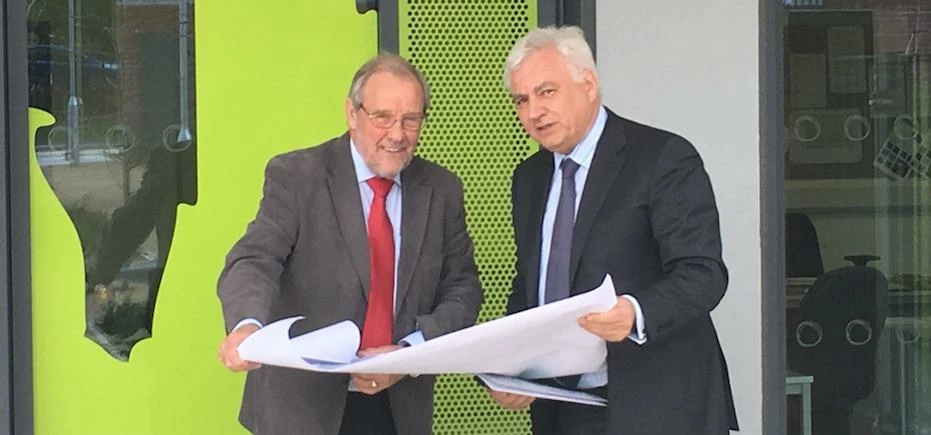 Richard Caborn and Nigel Knowles looking at OLP plans outside of the Oasis Academy on site.