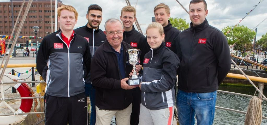 Peel Ports' apprentices with MAST founder Jim Graves and last year's Apprentice Ship Cup trophy.