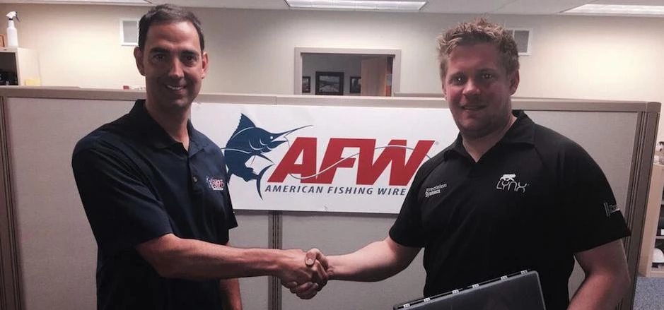Mike Shields (left) and Andy Petherick (right) shake hands on the deal at the AFW headquarters in Ph