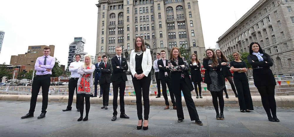 Partner Emma Stoddart (centre) pictured outside the Royal Liver Building with the sixth form student