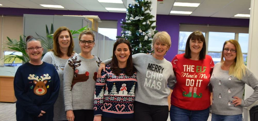 SureCare staff  in their Christmas jumpers
