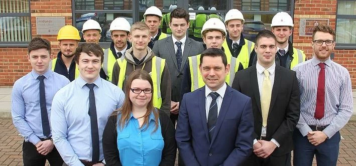 Persimmon Homes Midlands managing director Richard Oldroyd with trainees and apprentices at the comp