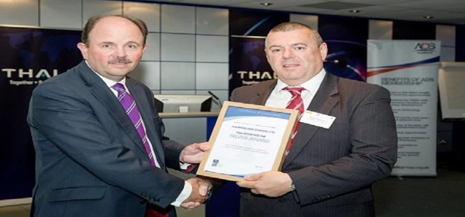 Phil Curnock (left), head of supply chain at ADS, presents Mark Robinson, Thermacore Europe quality 