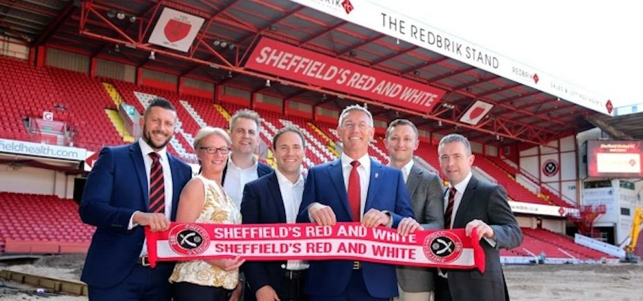Redbrik signs for the Blades. Representatives from Redbrik and Sheffield United celebrate the new sp